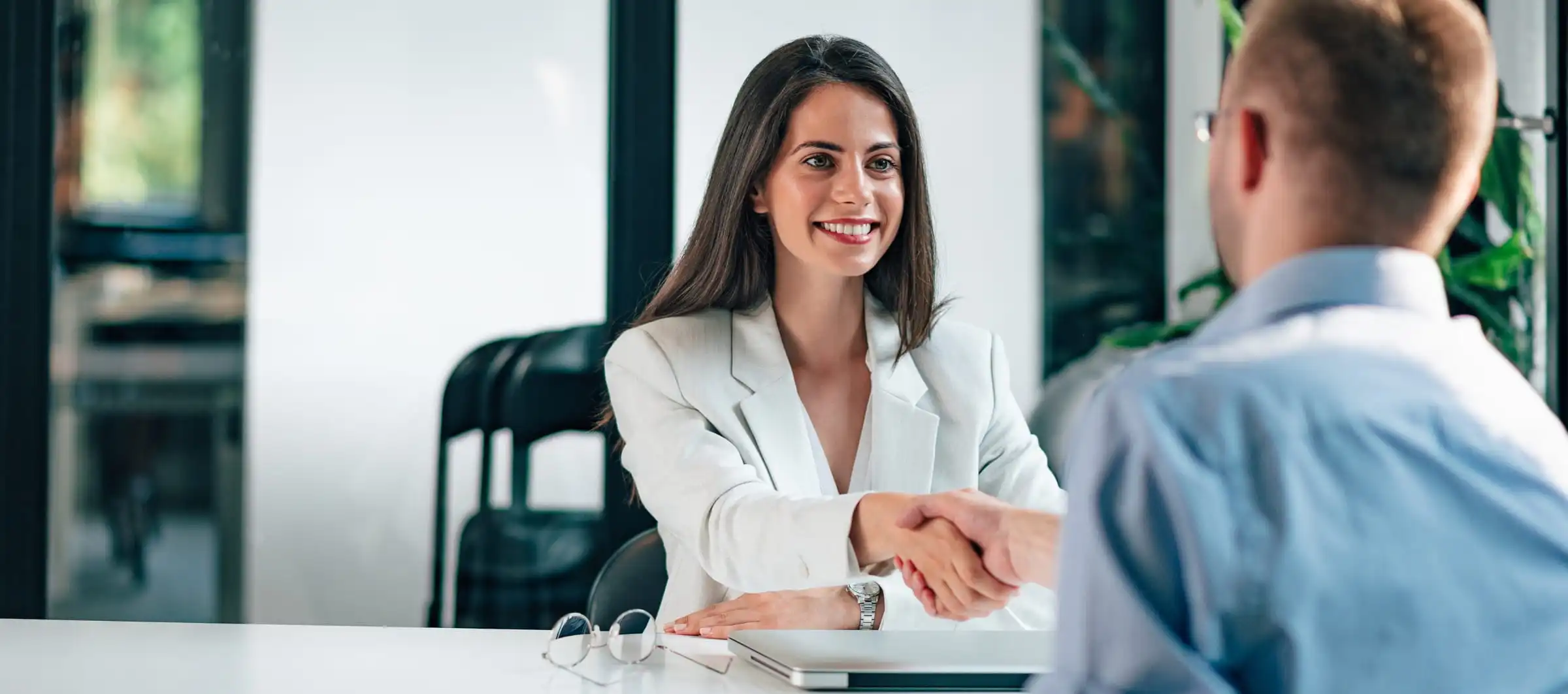 Professional job interview handshake at office desk